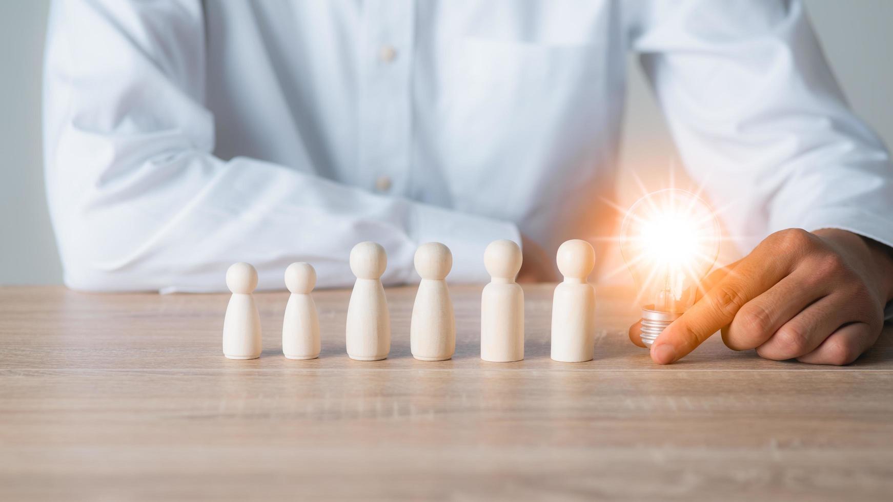 Young businessman holding a light bulb photo