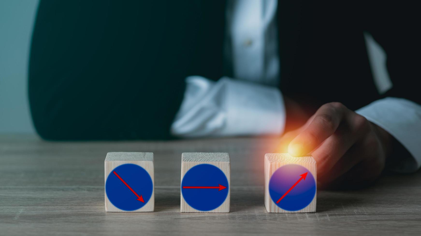 Business people hold wooden blocks on their desks photo