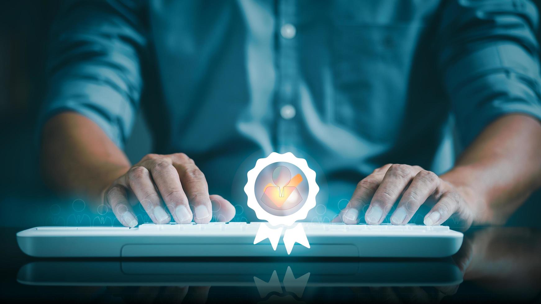 A young businessman is typing a document on a keyboard photo