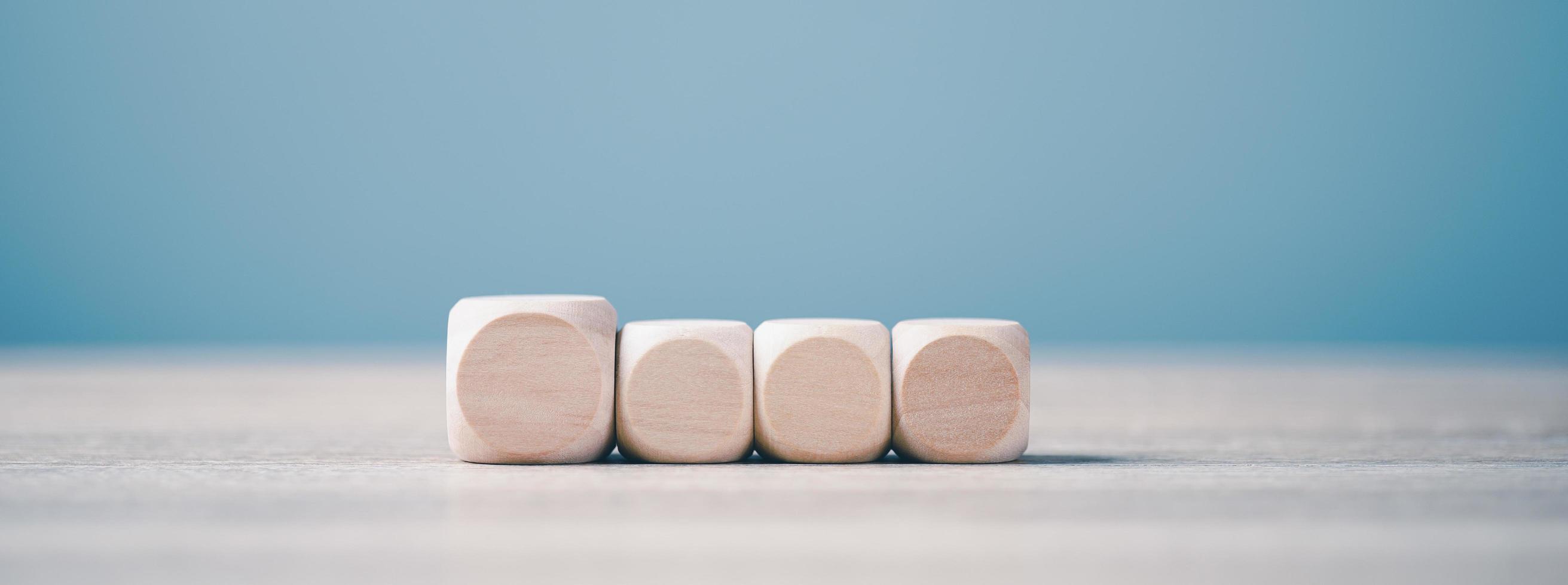 Square wooden blocks lined up on a wooden workbench photo