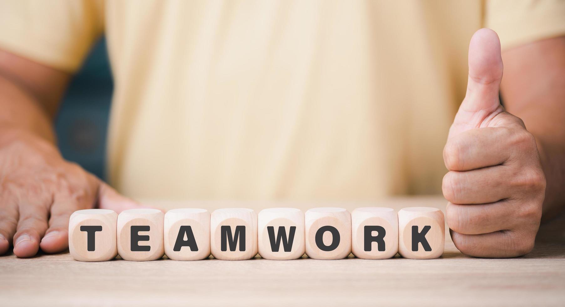 A young businessman with a wooden block line of leadership represents teamwork, business ideas and supportive friendships and cooperation of employees and friends. for the success of the organization photo