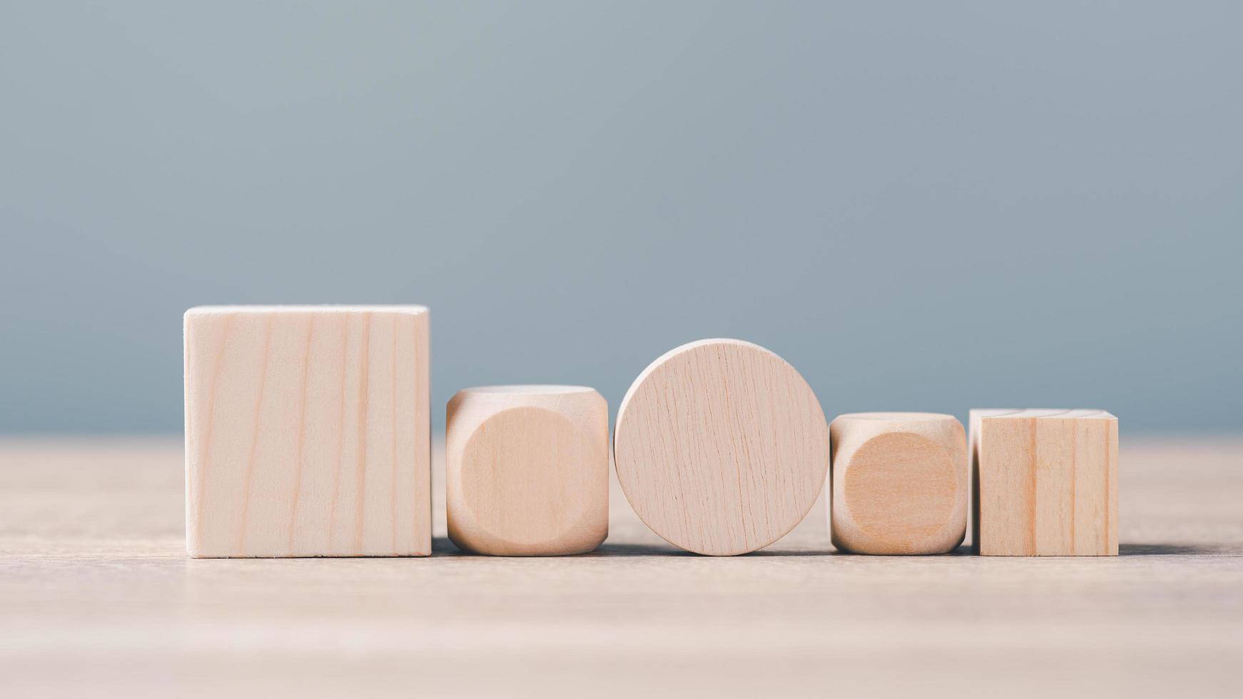 Wooden blocks of various sizes and shapes. arranged in an orderly row photo