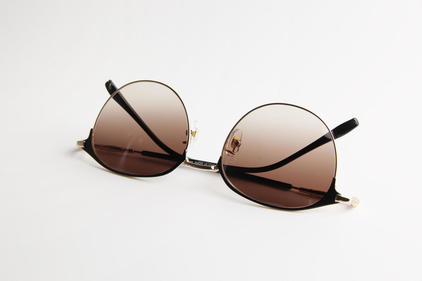 Brown sunglasses on white photo