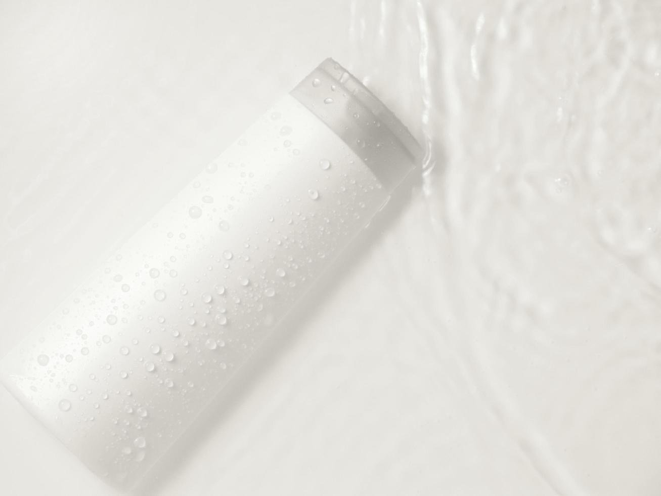 White bottle flacon cosmetics beauty product for skin care face cream and body lotion shower gel natural organic cosmetology in water drop pure beautiful. photo