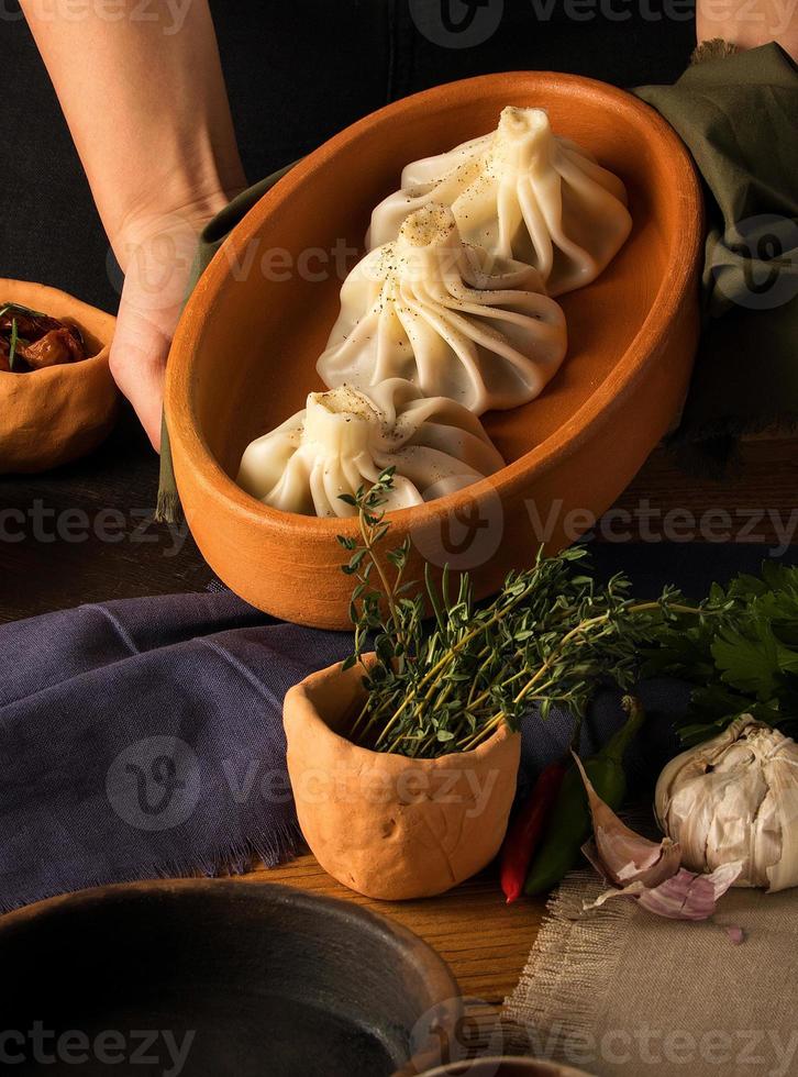 A vertical shot of a luxurious restaurant table with a gourmet khinkali dish photo