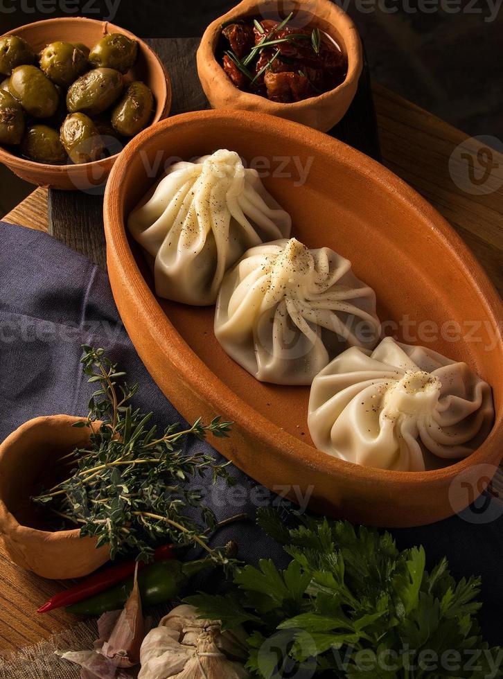 A vertical shot of a luxurious restaurant table with a gourmet khinkali dish photo
