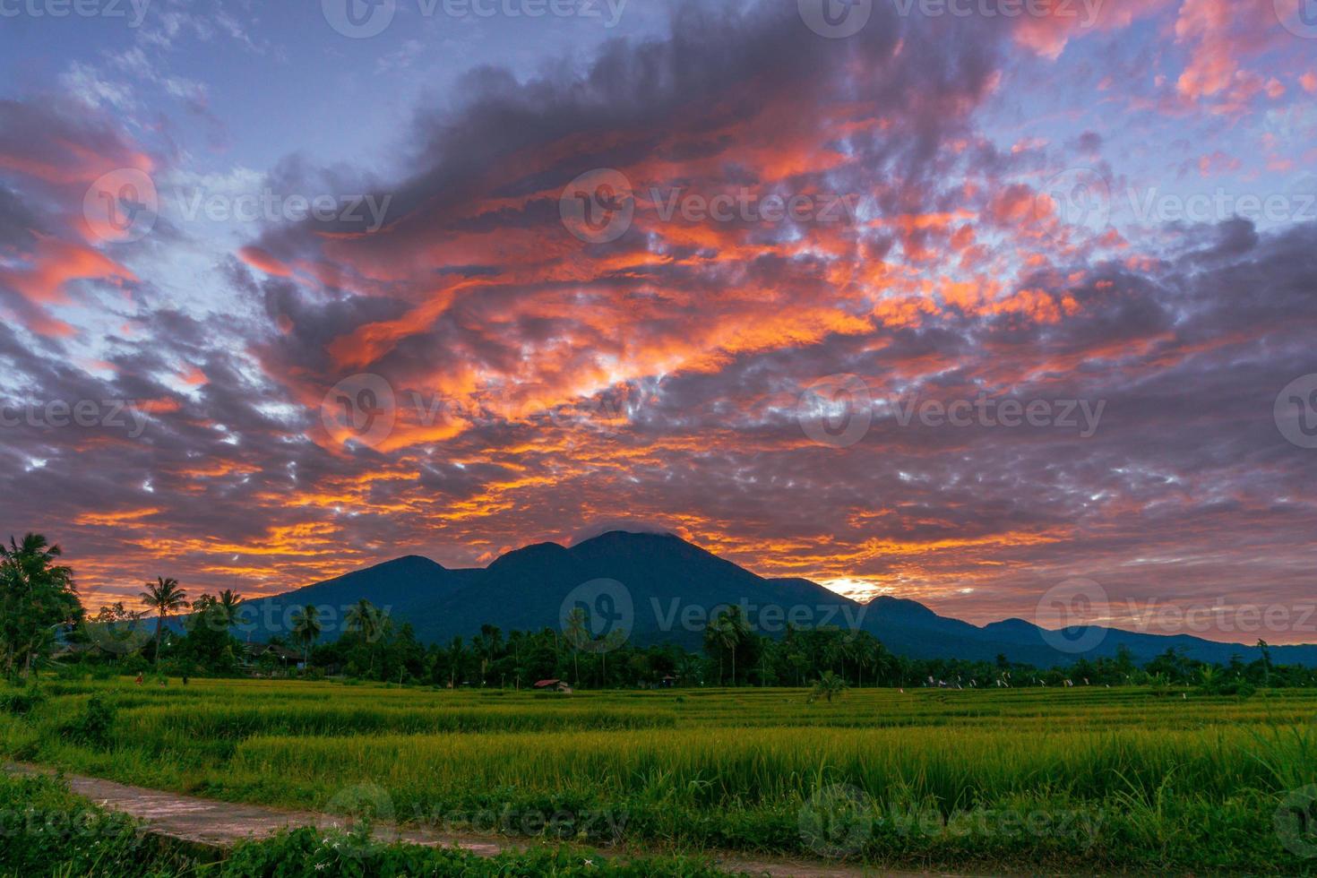 panoramic background of Indonesia's beautiful natural scenery. morning view with sunrise over the mountain photo