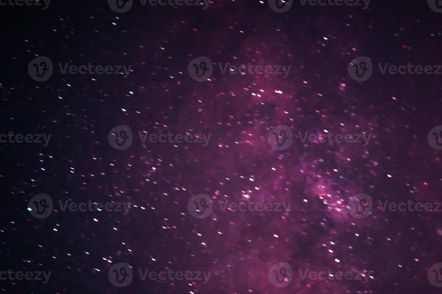 Colorful galaxy with dominant red and purple with star galaxy in outer space photo