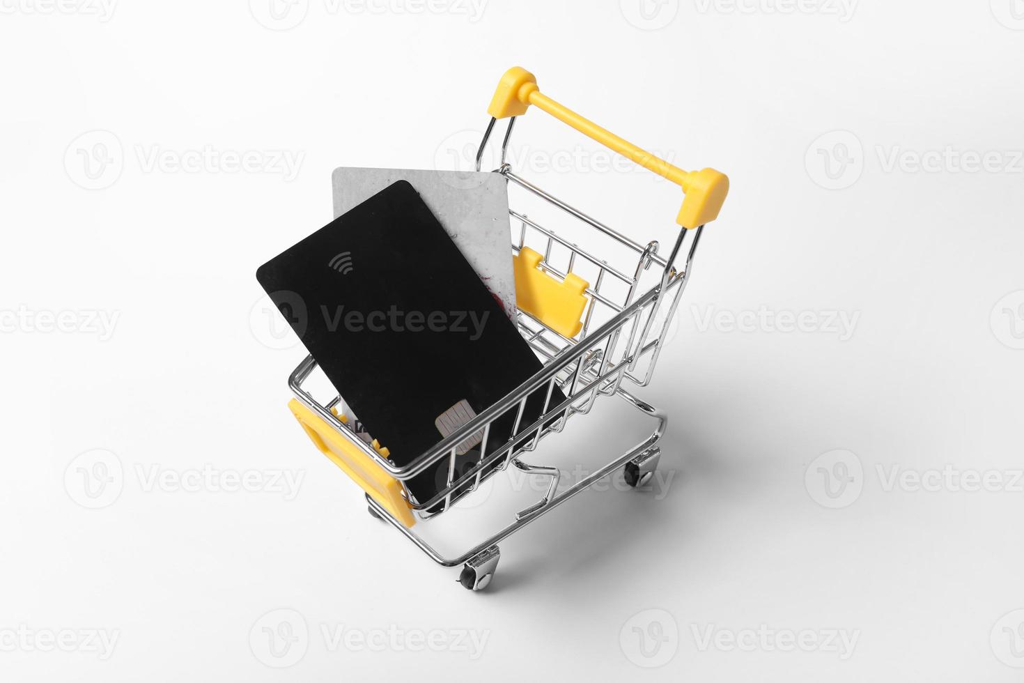 credit cards in shopping cart isolated on a white background. Purchasing power and living wage concept photo
