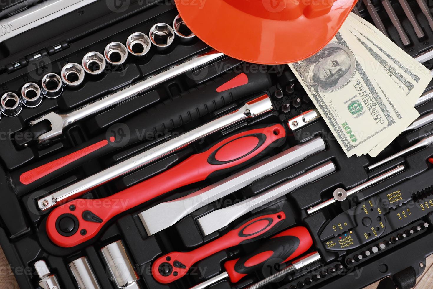 Toolbox, tools kit detail, dollar bills and orange protective helmet close up. instruments. set of tools. car tool kit. tool set background. instruments for repair. money for repairs photo