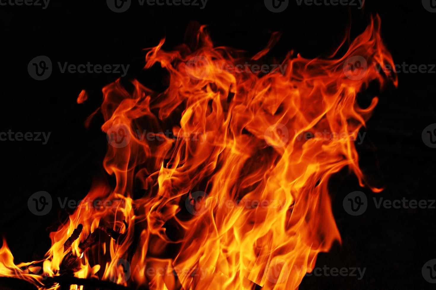 Fire creates infinity shapes when it burns. The orange from the flame and the black backgroud creates interesting textures. Flames from hell. Burning power. photo