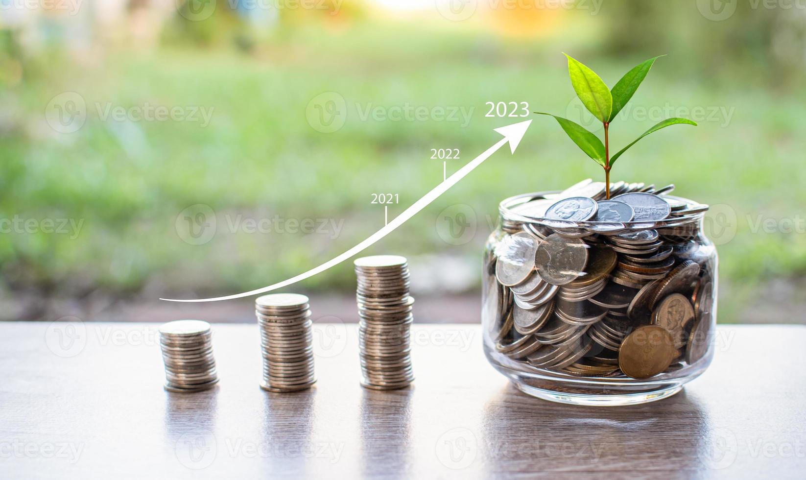 A jar of coins is placed on a table outside an office. concept, finance, banking, interest, inflation, economy, business. copy space on left for design. Selective focus. Closeup, blurred background photo