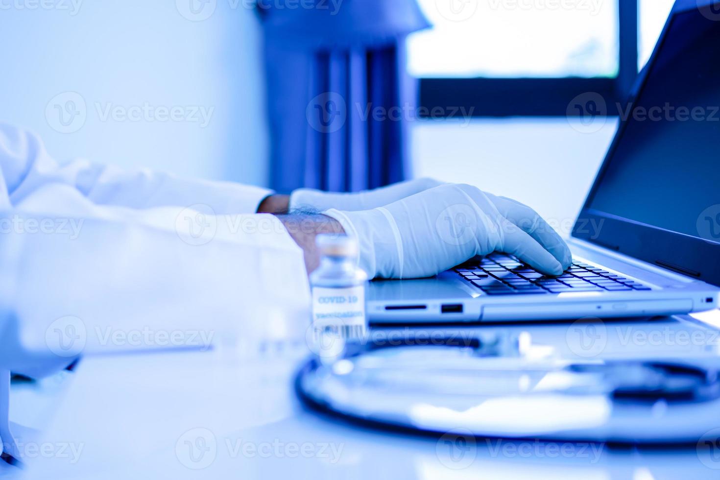 A doctor typing the data and description into a server computer with a ...