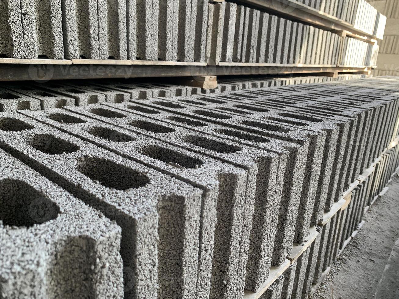 collection of cement block or brick lined up in warehouse photo