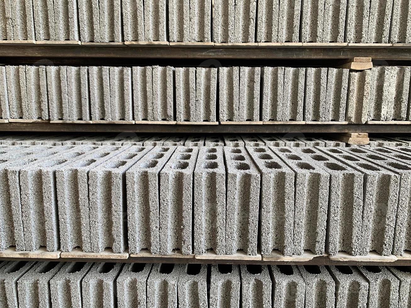 collection-of-cement-block-or-brick-lined-up-in-warehouse-9389963-stock