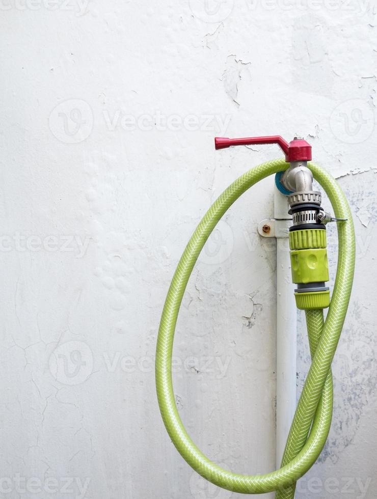 Metal faucet with the watering hose. photo