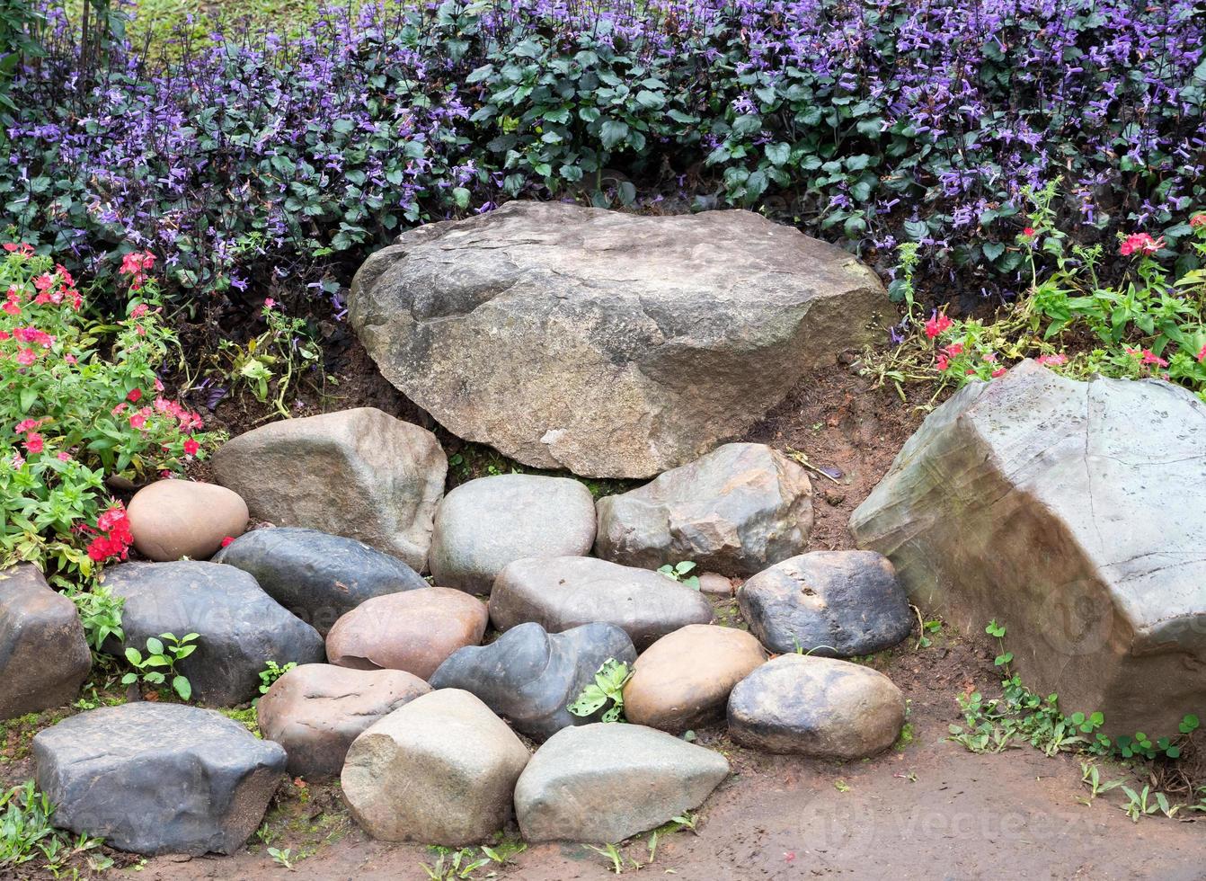 Stone seat in the flower row. photo