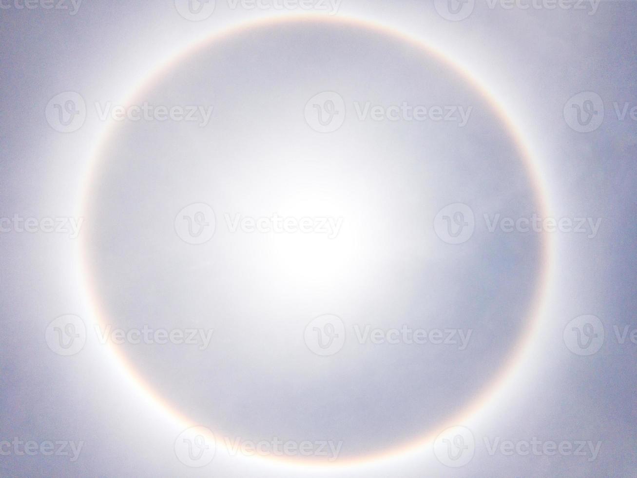 Large sun halo on the clear blue sky. photo