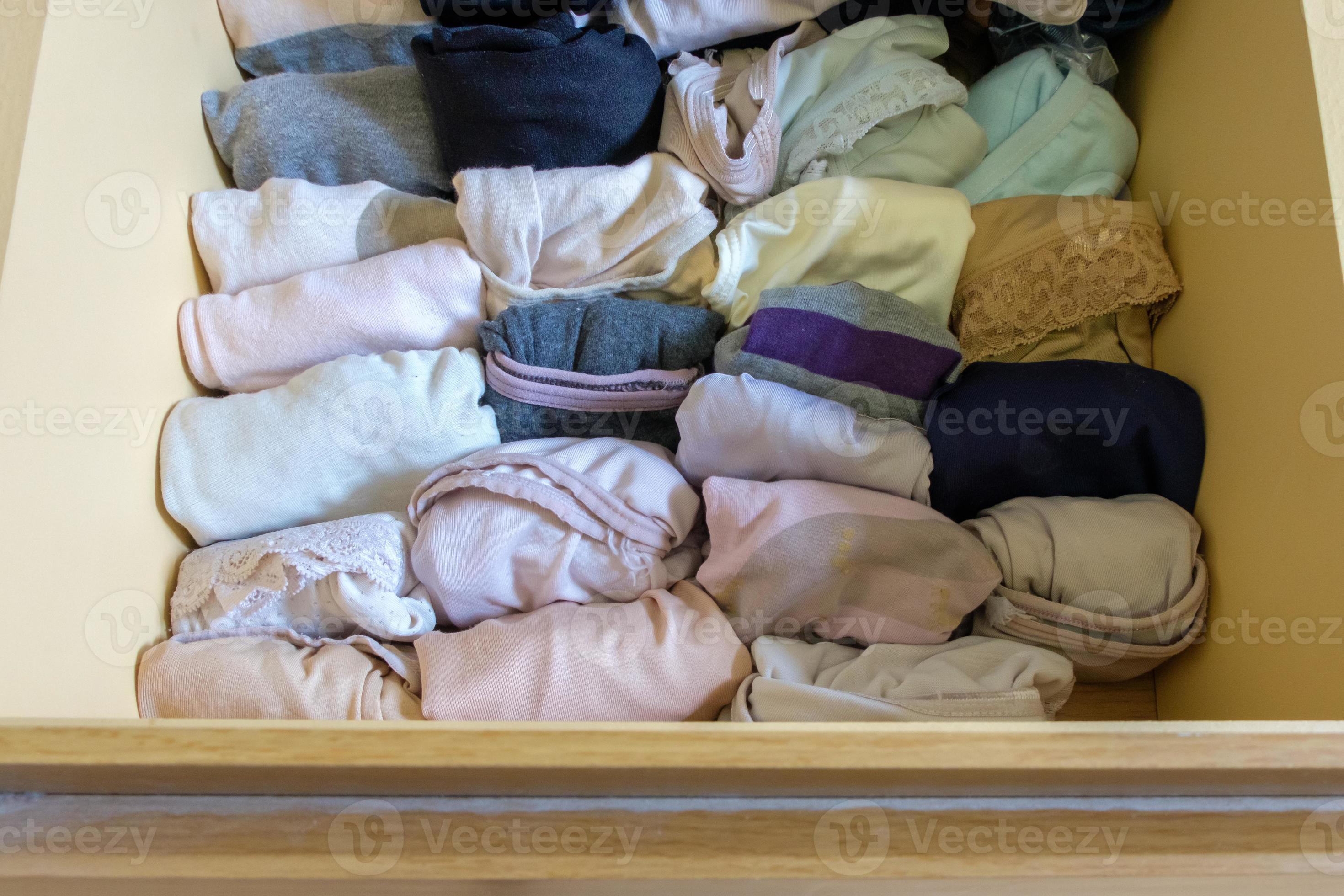 The variety of adult panties in the wooden drawer of the large wardrobe.  9395175 Stock Photo at Vecteezy