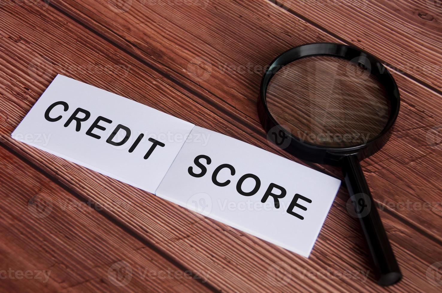 Notepad with Credit Score text on wooden table. photo