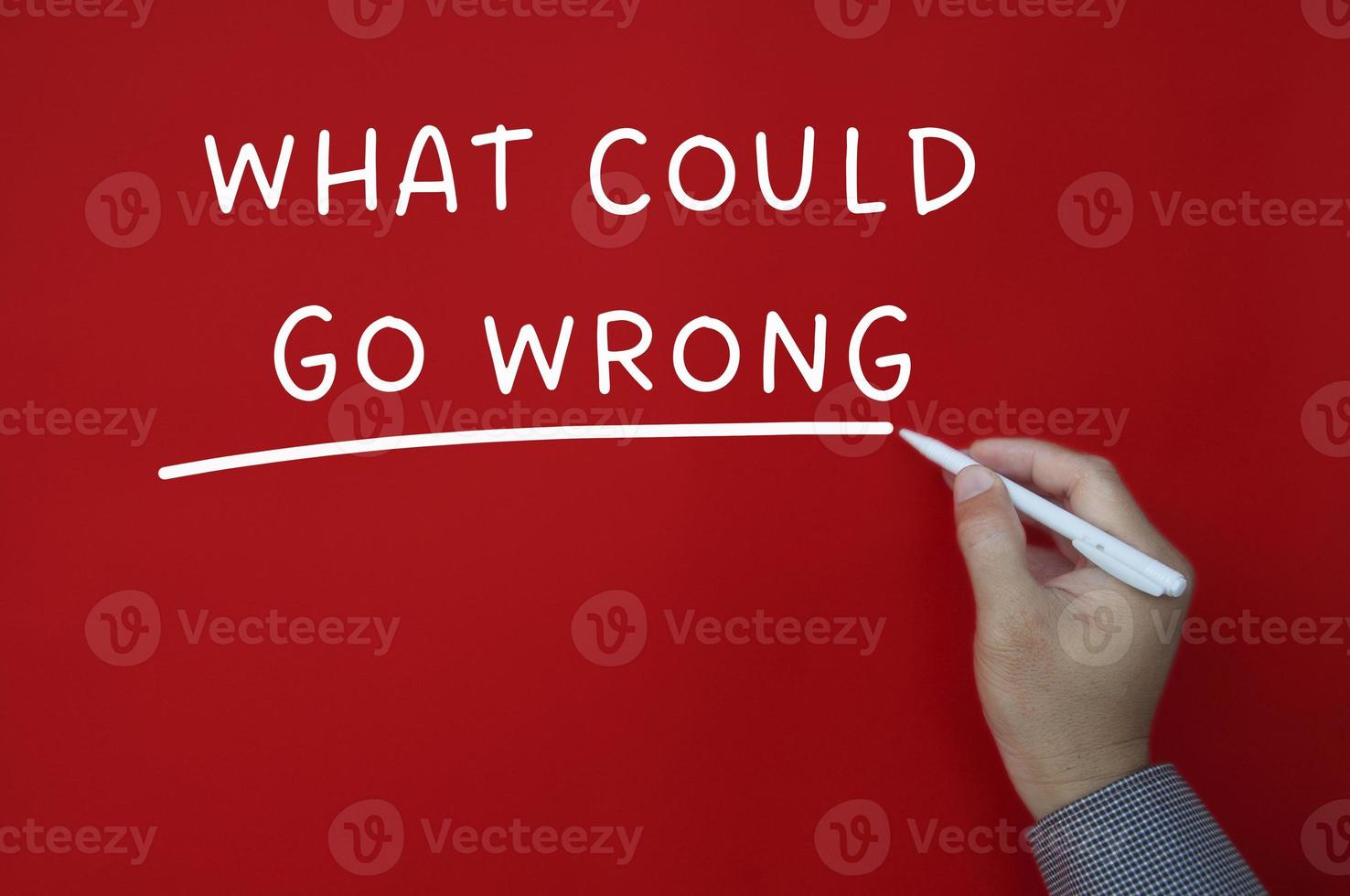 What could go wrong text on red cover background. photo