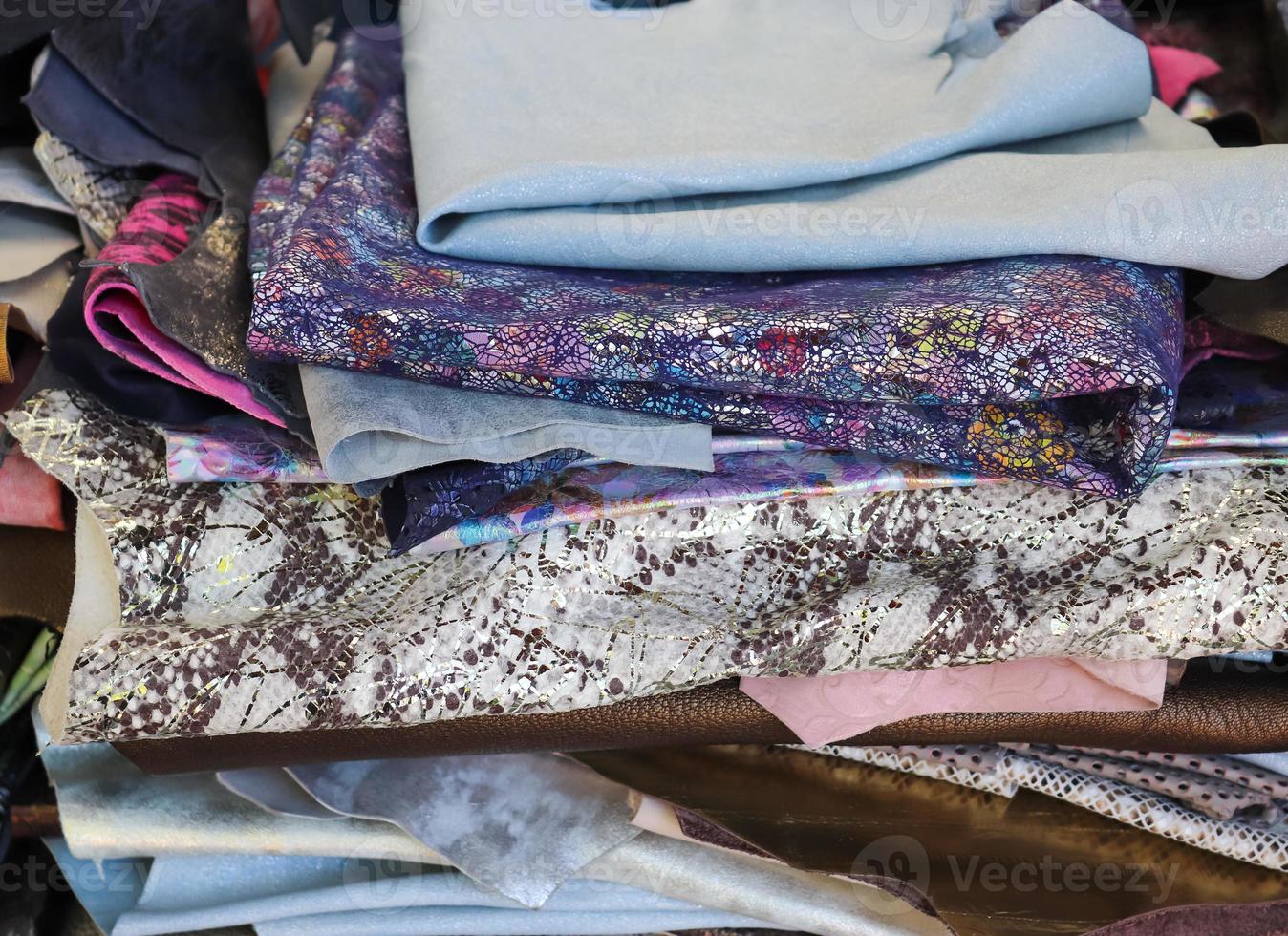 Close up view on samples of cloth and fabrics in different colors found at a fabrics market photo