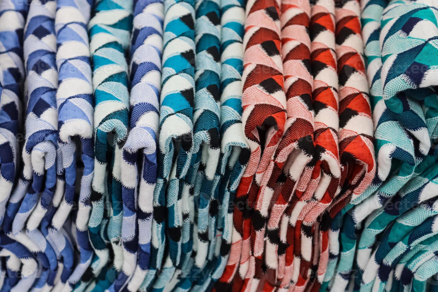Detailed close up view on samples of cloth and fabrics in different colors found at a fabrics market photo