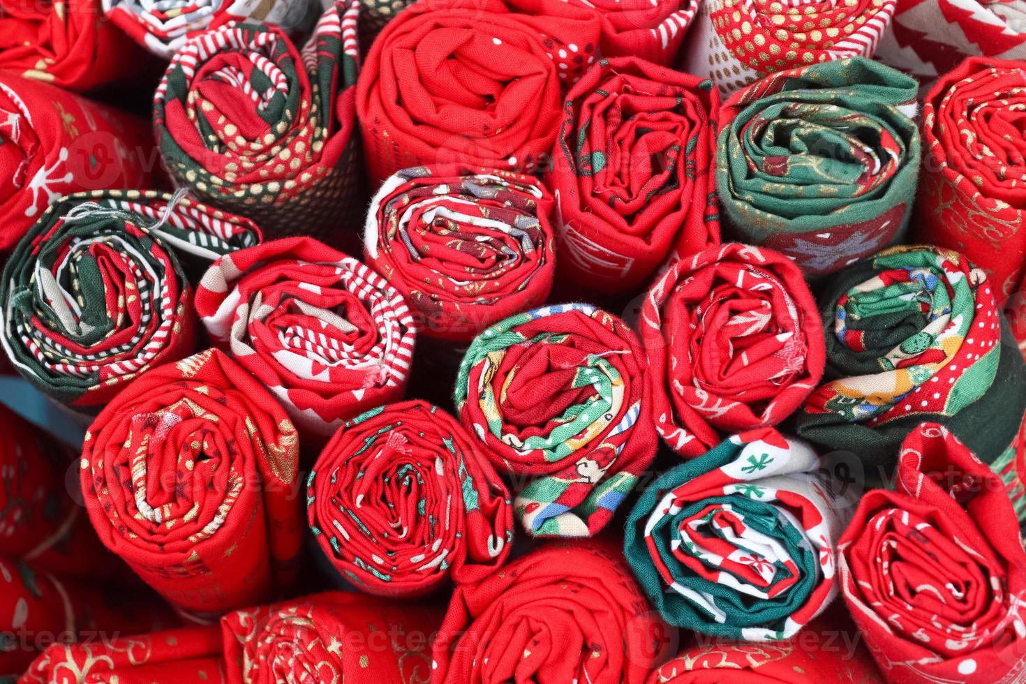 Close up view on samples of cloth and fabrics in different colors found at a fabrics market photo