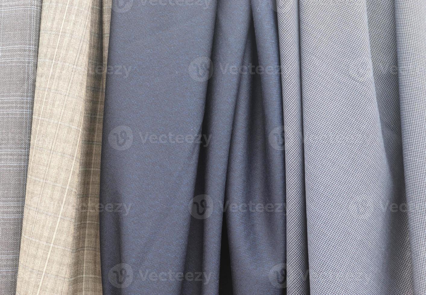Detailed close up view on samples of cloth and fabrics in different colors found at a fabrics market photo