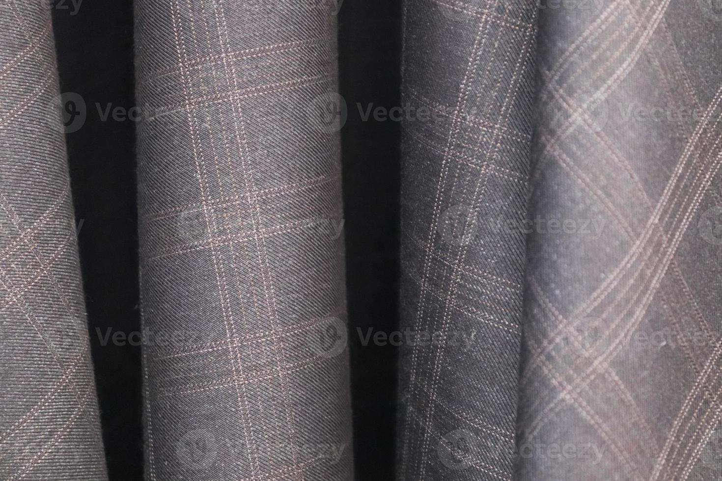 Close up view on samples of cloth and fabrics in different colors found at a fabrics market photo