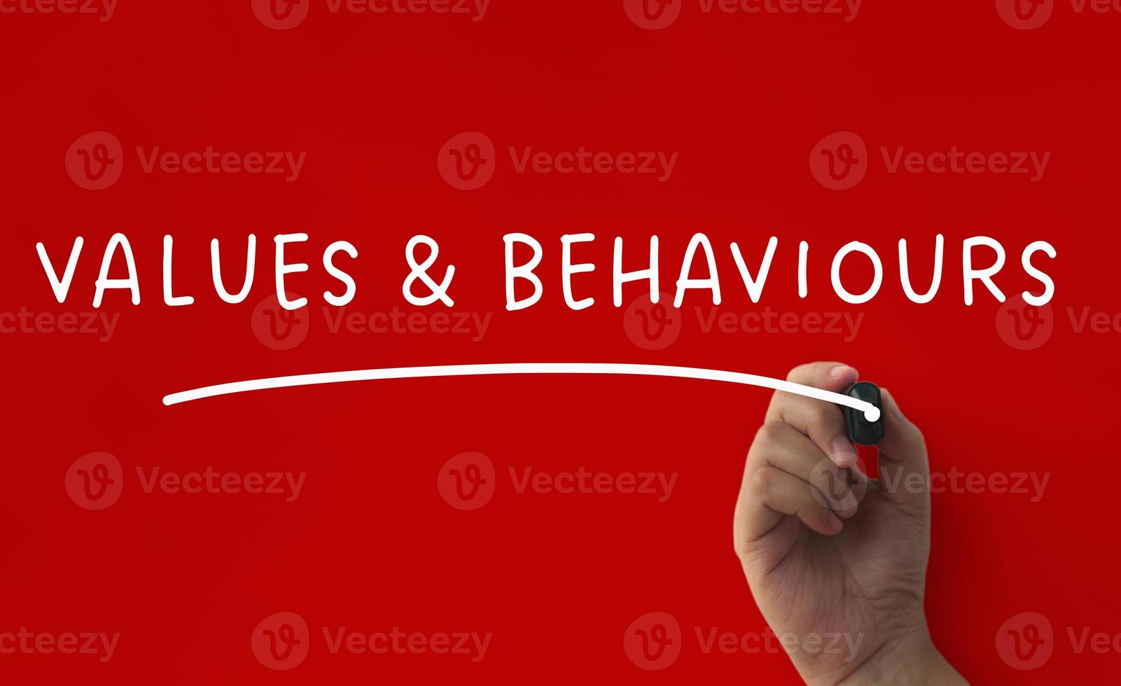 Values and behaviour text on red cover background. Conceptual photo