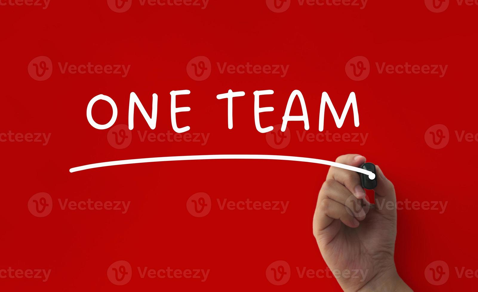 One team text on red cover background. Teamwork concept photo