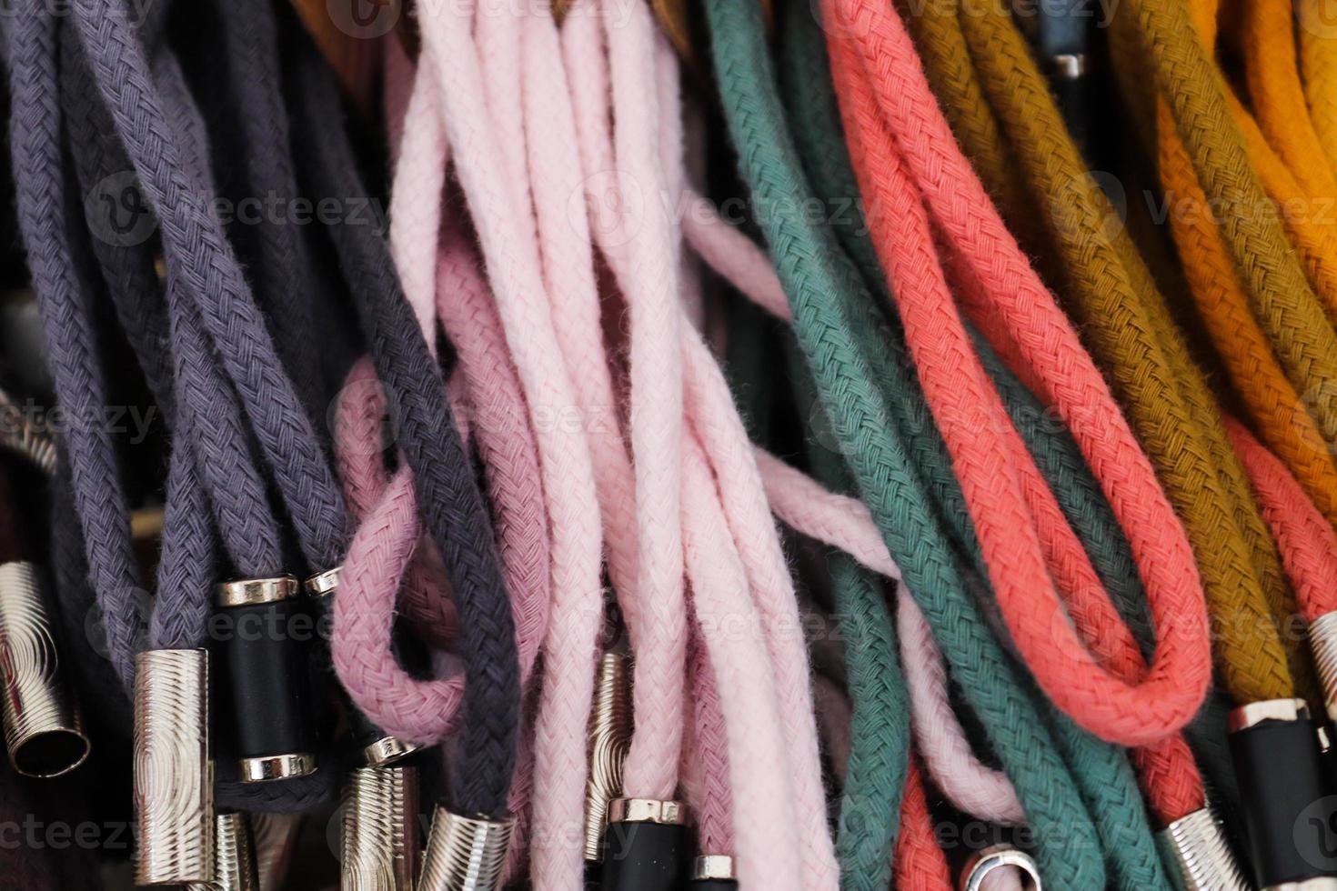 Detailed close up view on samples of cloth and fabrics in different colors found at a fabrics market photo