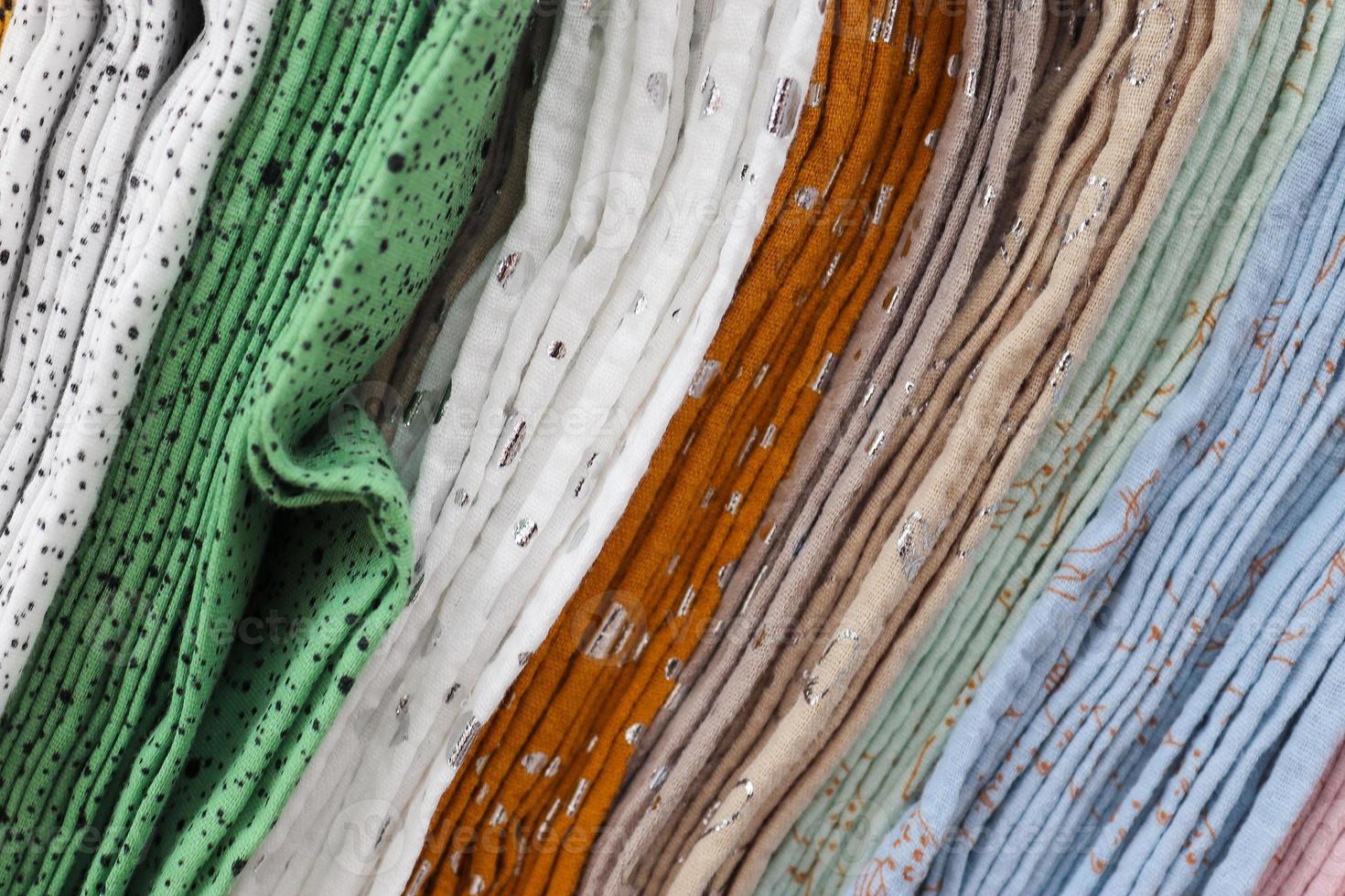 Detailed close up view on samples of cloth and fabrics in different colors found at a fabrics market photo