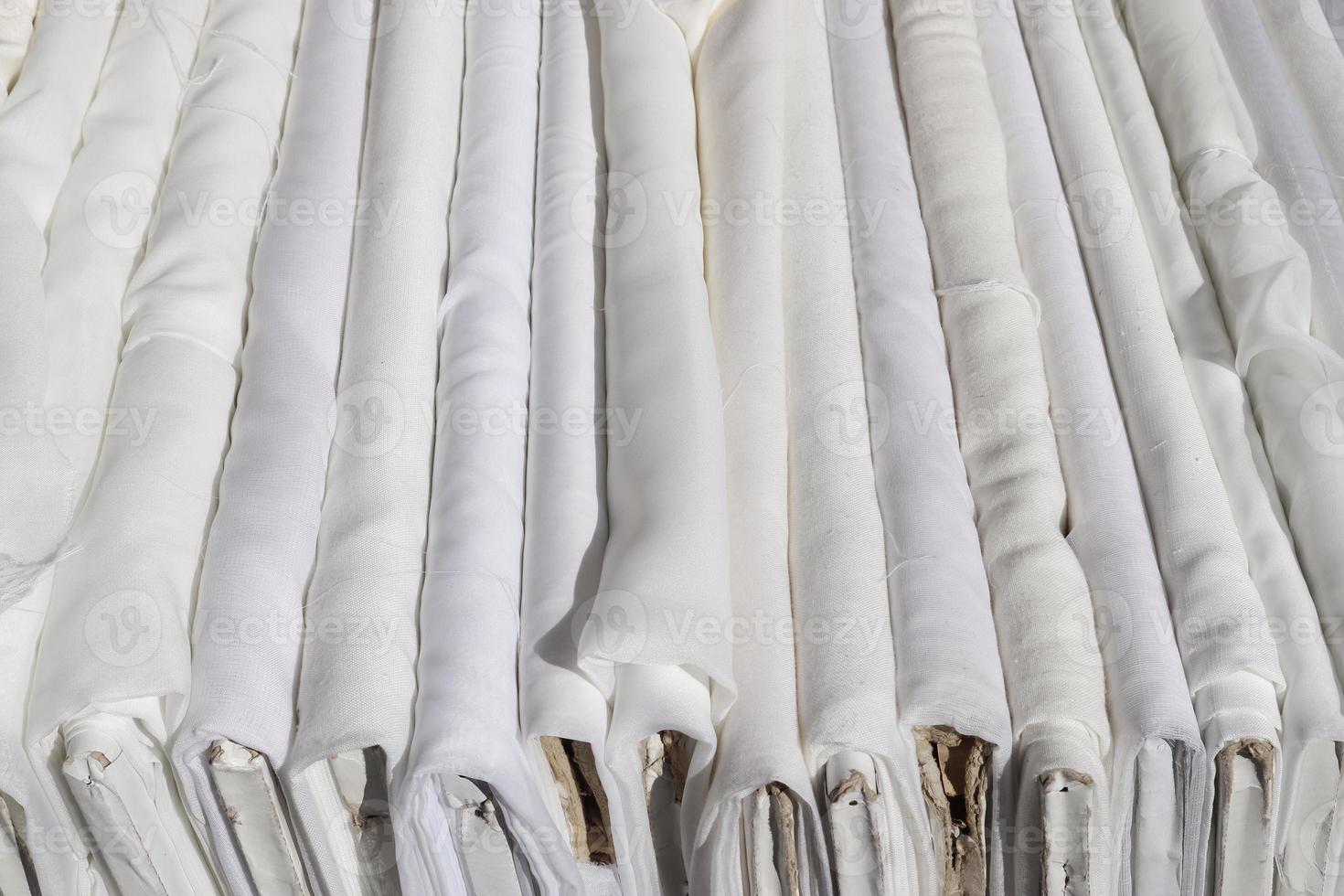Detailed close up view on samples of cloth and fabrics in different colors found at a fabrics market photo