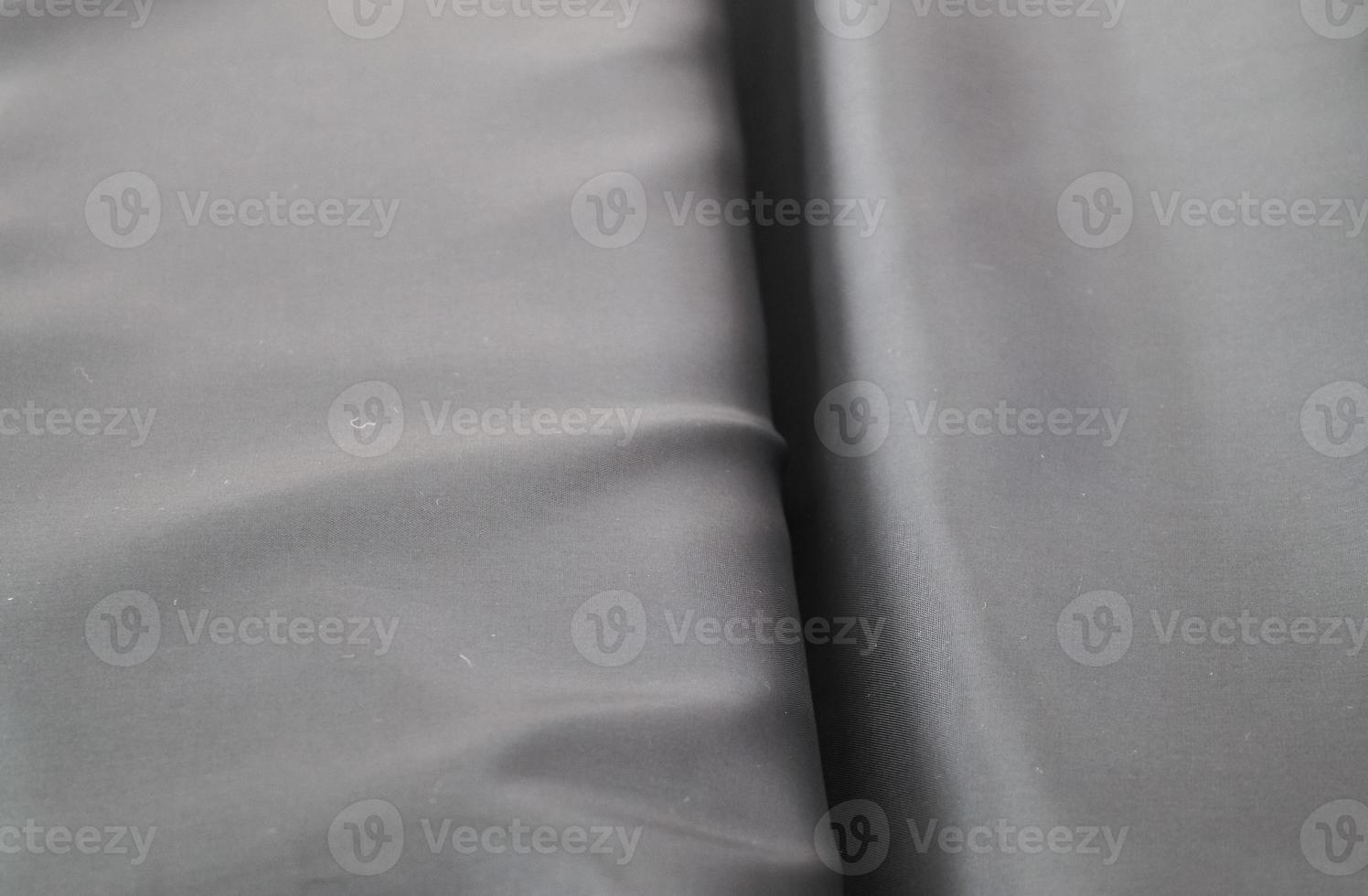 Detailed close up view on samples of cloth and fabrics in different colors found at a fabrics market photo
