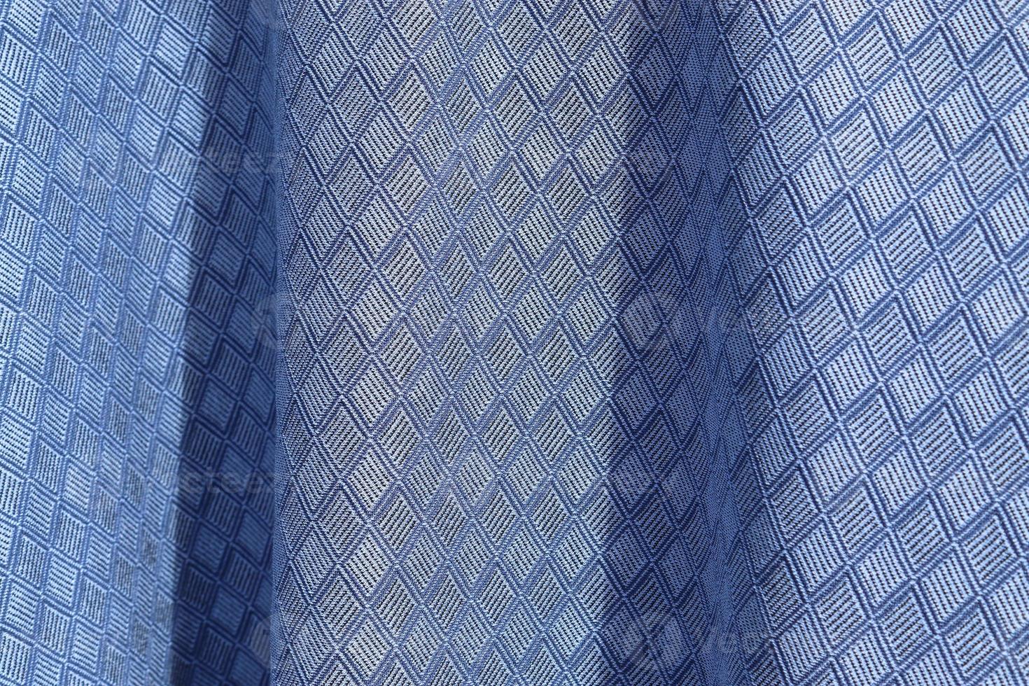 Detailed close up view on samples of cloth and fabrics in different colors found at a fabrics market photo