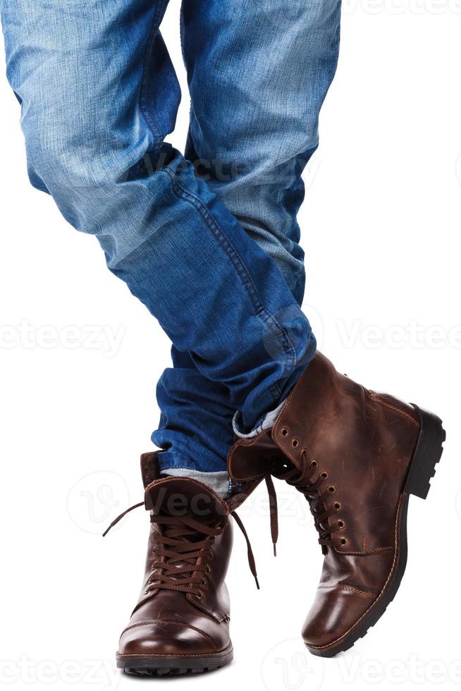 Male legs in jeans and leather boots photo