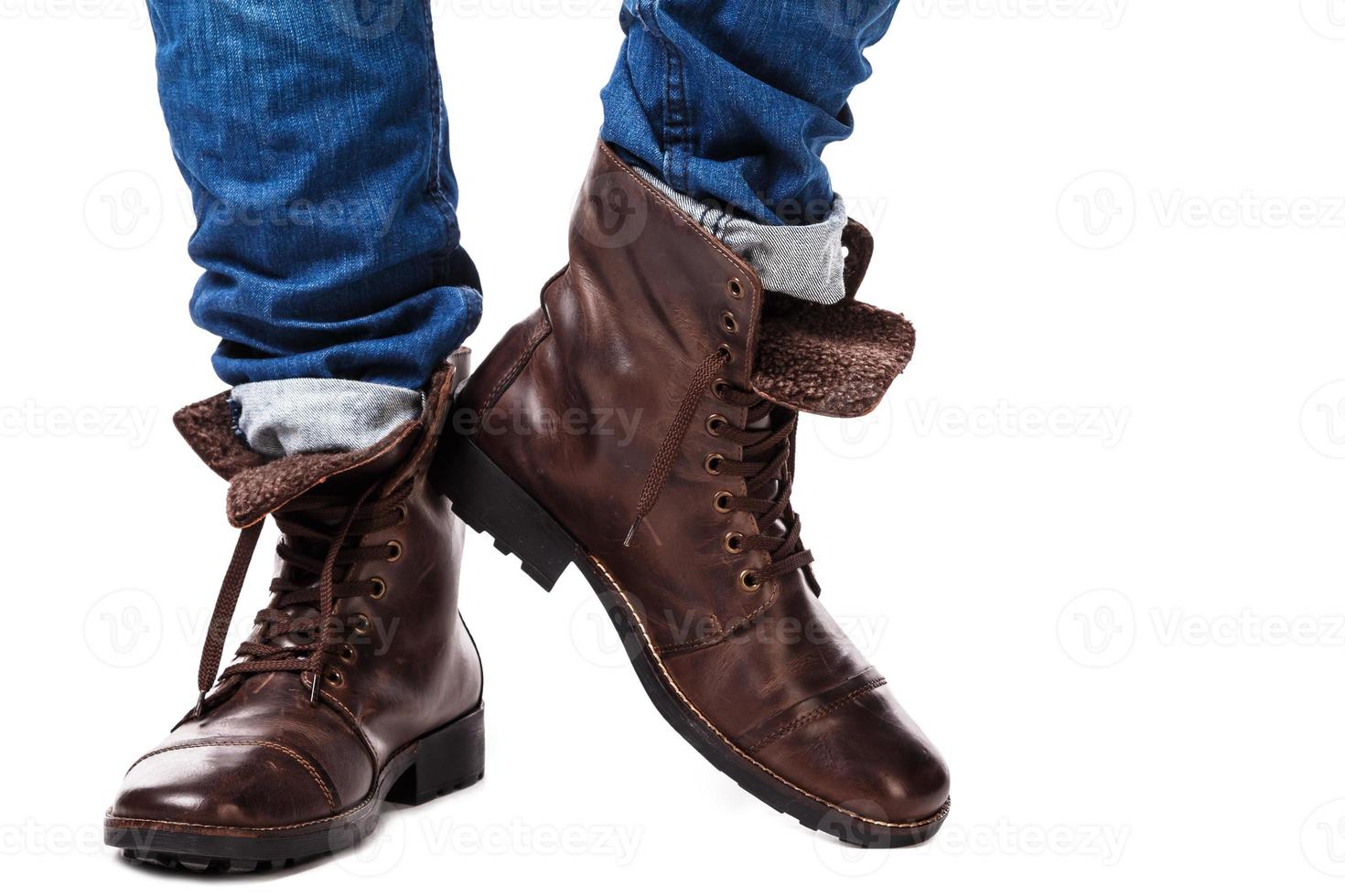 Male legs in jeans and leather boots photo