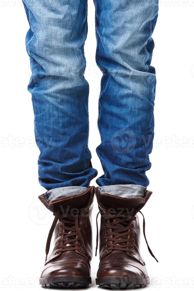 Male legs in jeans and leather boots photo