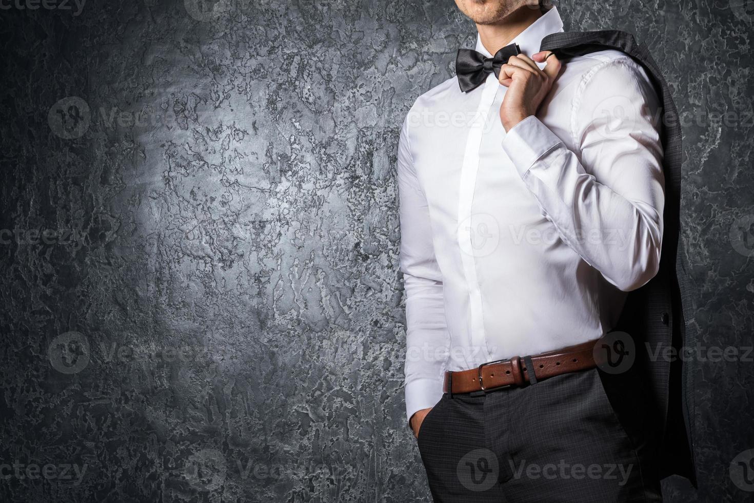 Man draped his jacket on the shoulder photo