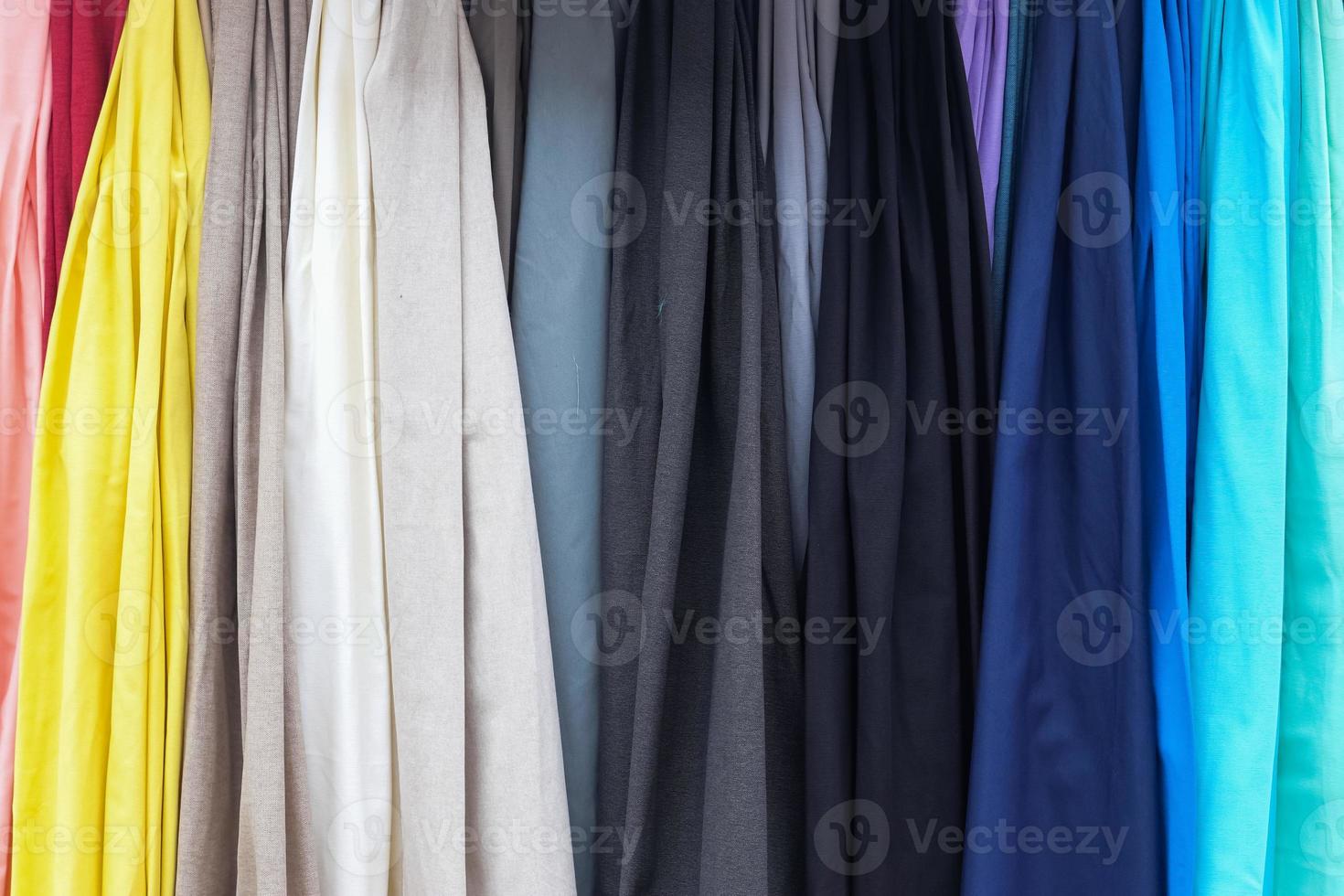 Detailed close up view on samples of cloth and fabrics in different colors found at a fabrics market photo