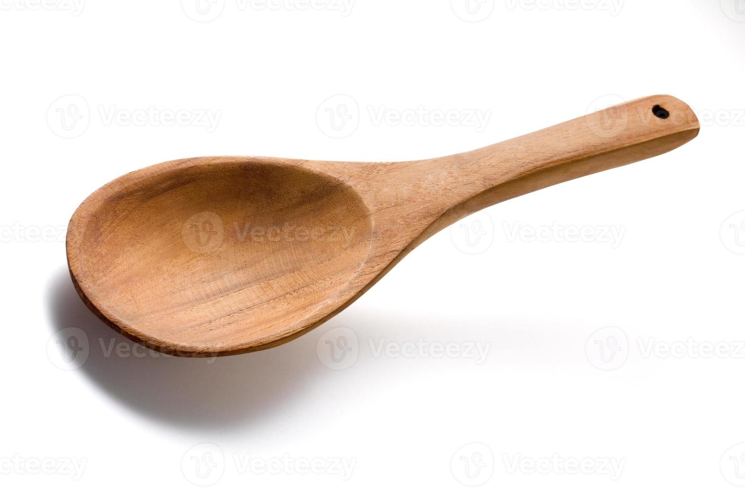 Empty wooden spoon isolated on white photo