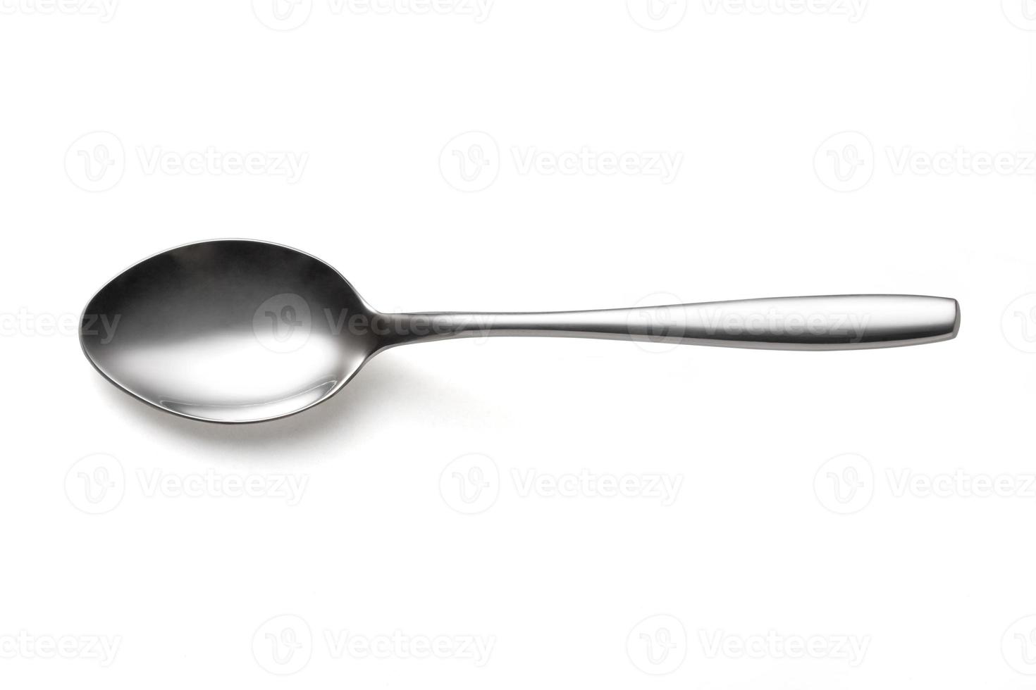 The metal shiny spoon isolated on white photo