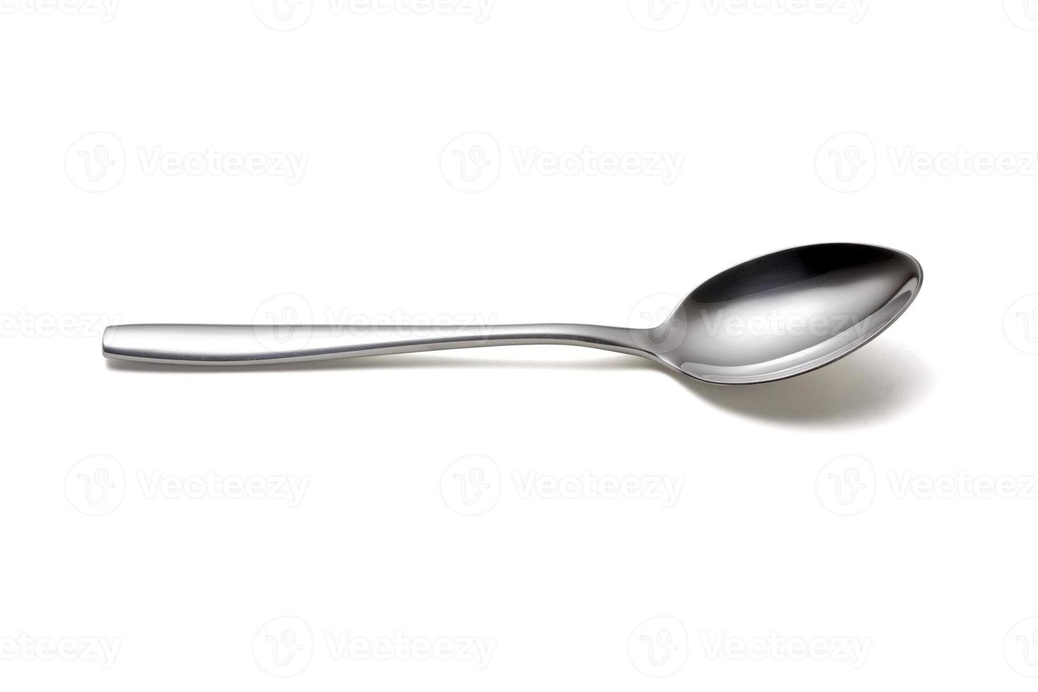 The metal shiny spoon isolated on white photo