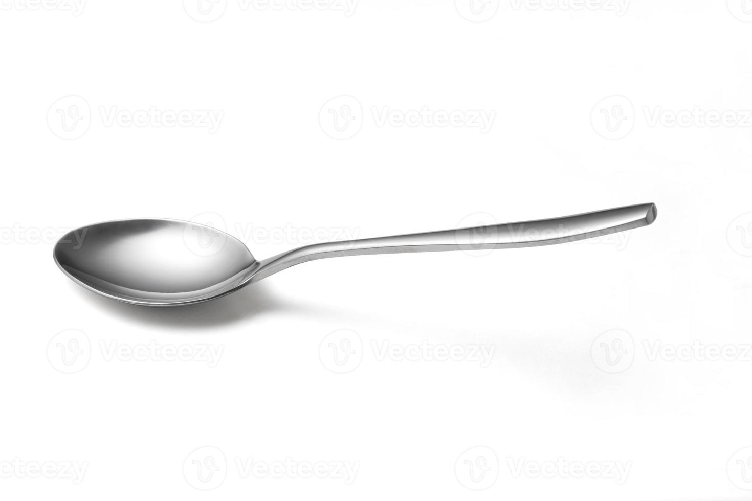 The metal shiny spoon isolated on white photo