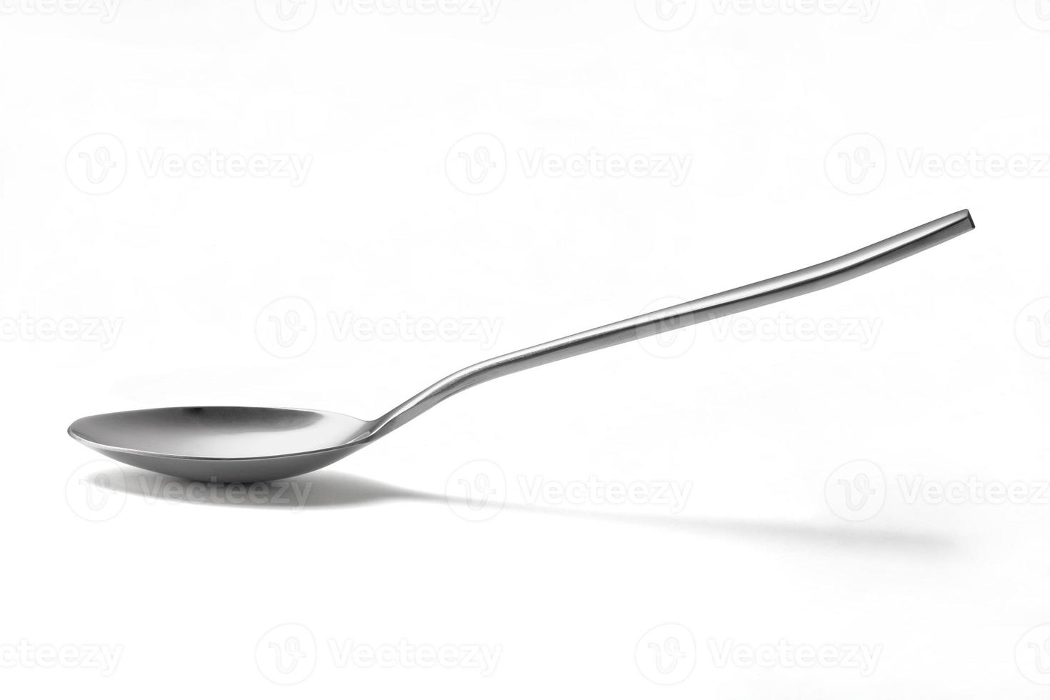 The metal shiny spoon isolated on white photo