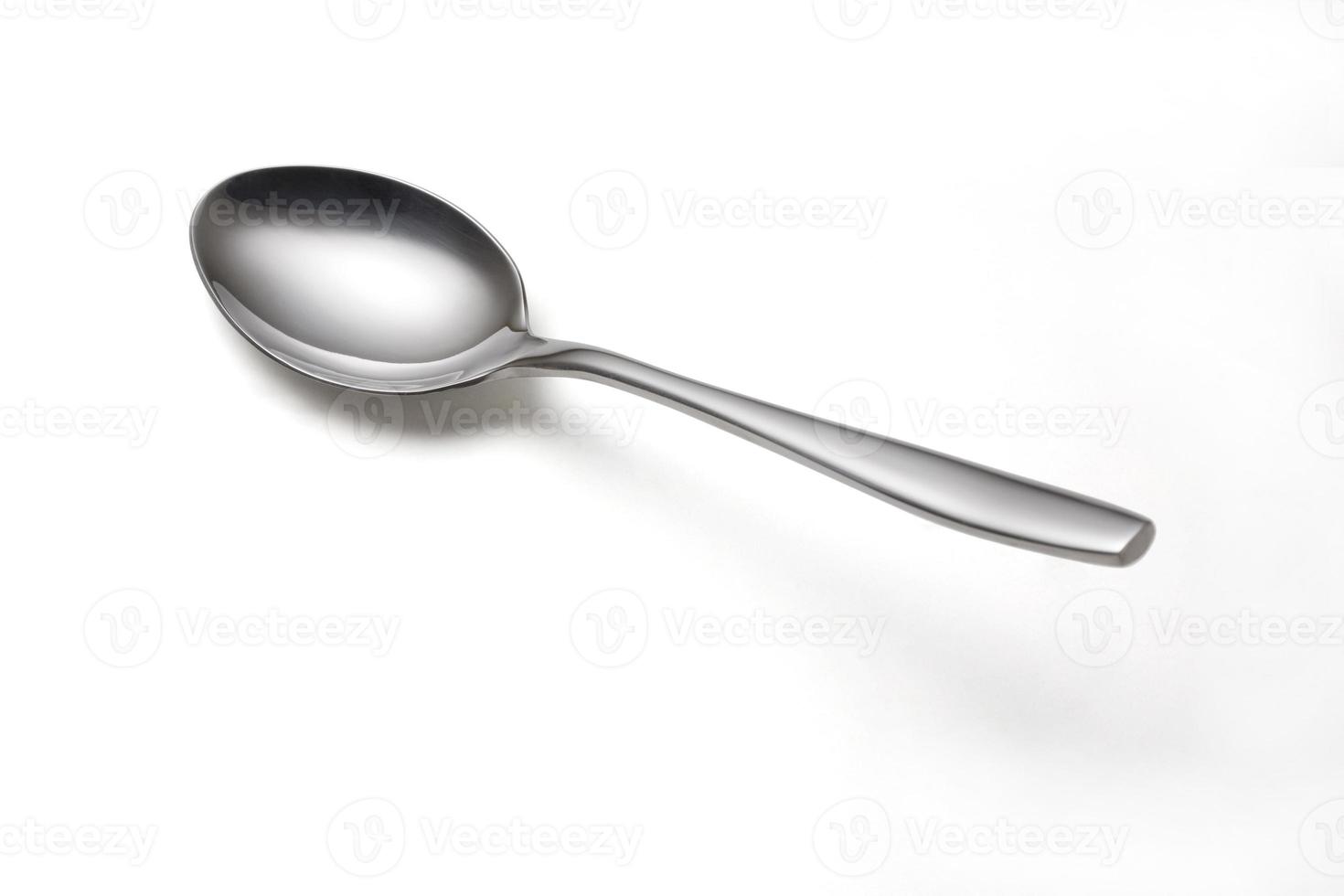 The metal shiny spoon isolated on white photo