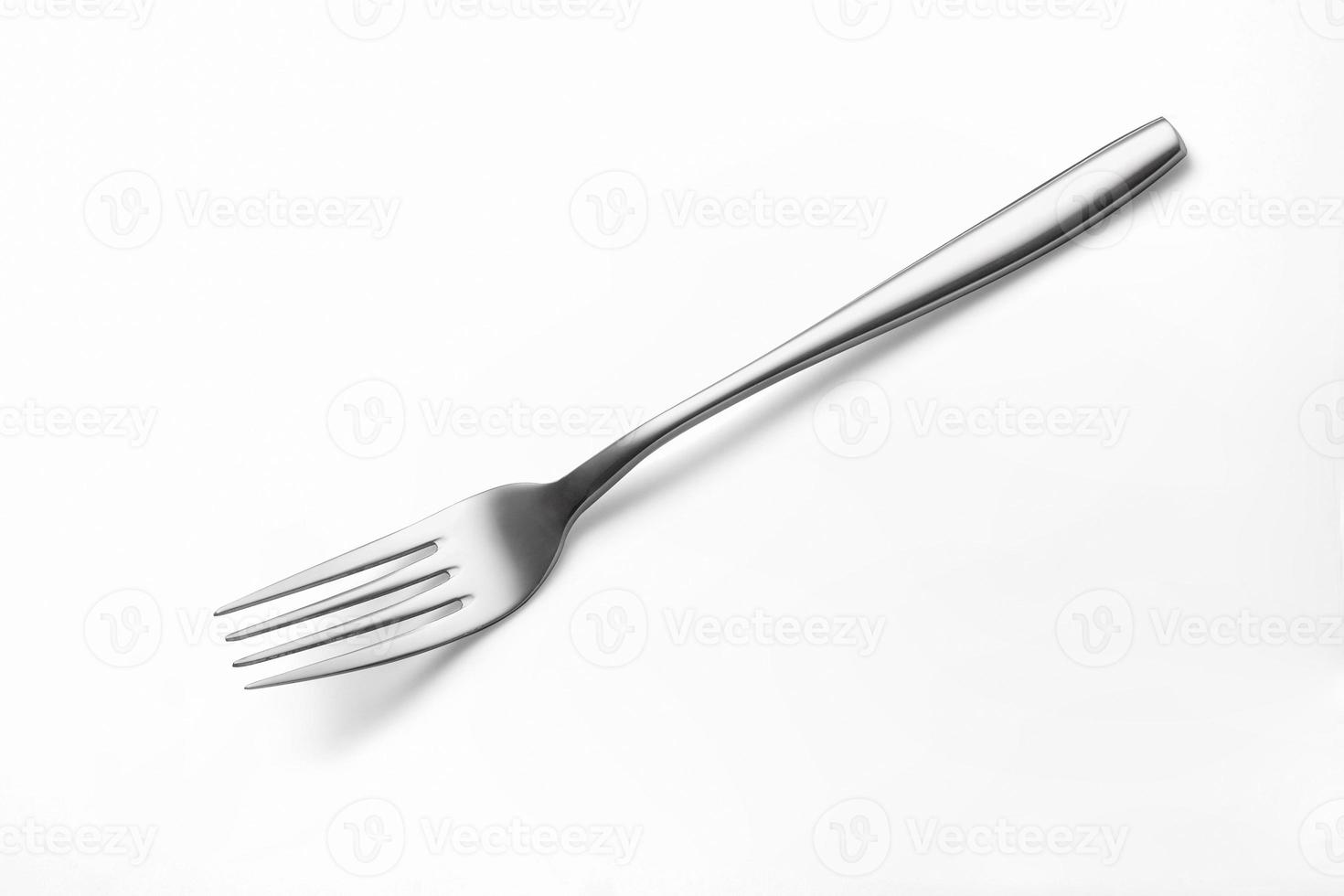 The metal shiny fork on white photo