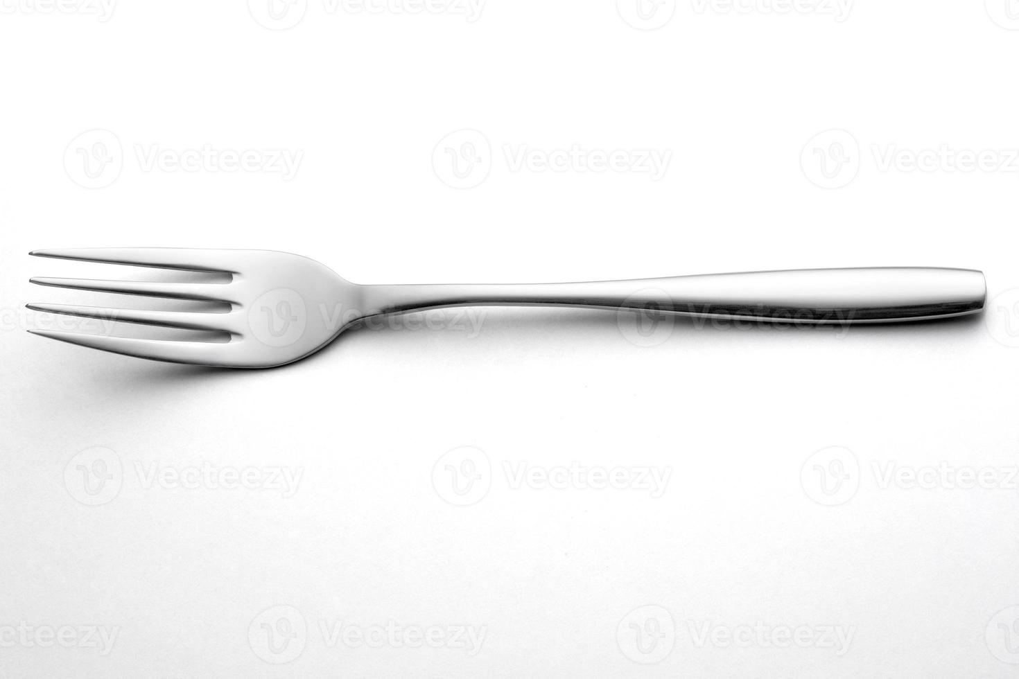 The metal shiny fork on white photo